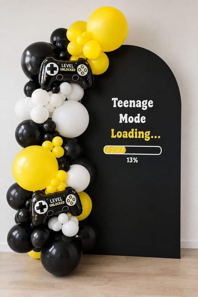 Teenage Mode Loading 13th birthday gaming party with black, yellow, and white balloons, game controller decorations, and a Level Unlocked backdrop.
